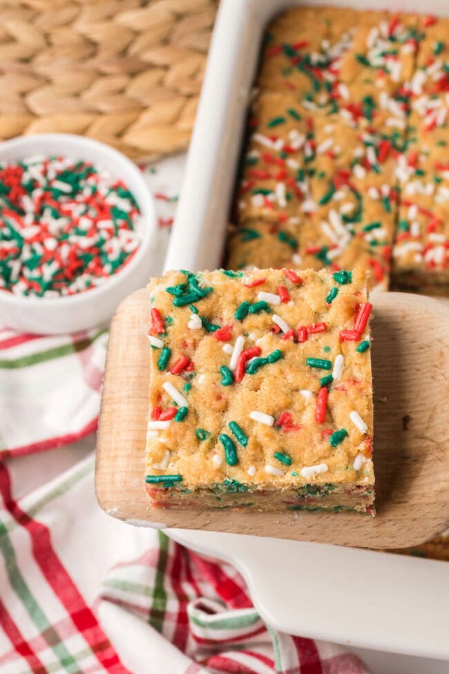 Overhead view of sliced Christmas Blondies with holiday sprinkles.