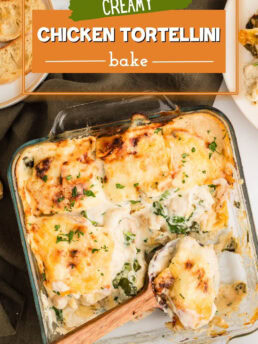 Chicken Tortellini Casserole baked in a square glass dish with a wooden spoon for serving, topped with melted cheese.