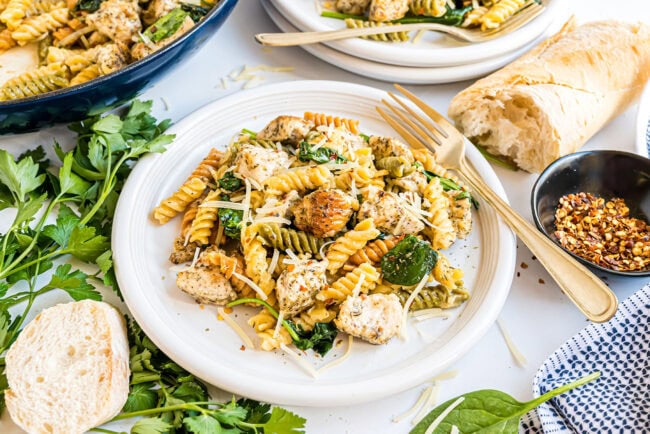One pan creamy garlic chicken pasta served on white plates