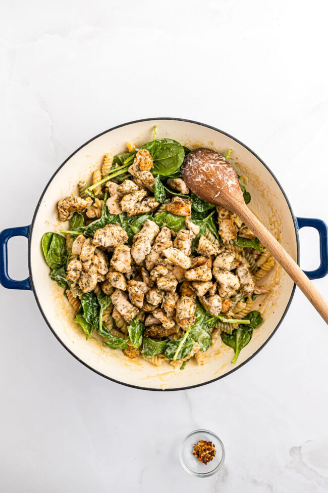 One pan creamy garlic chicken pasta cooked with spinach