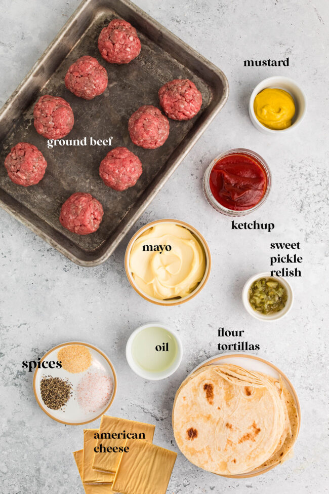 Ingredients for smash burger tacos including ground beef, tortillas, and toppings