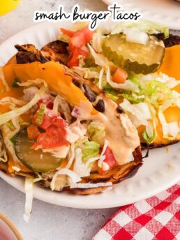 Smash burger tacos with melted cheese and toppings served on a plate