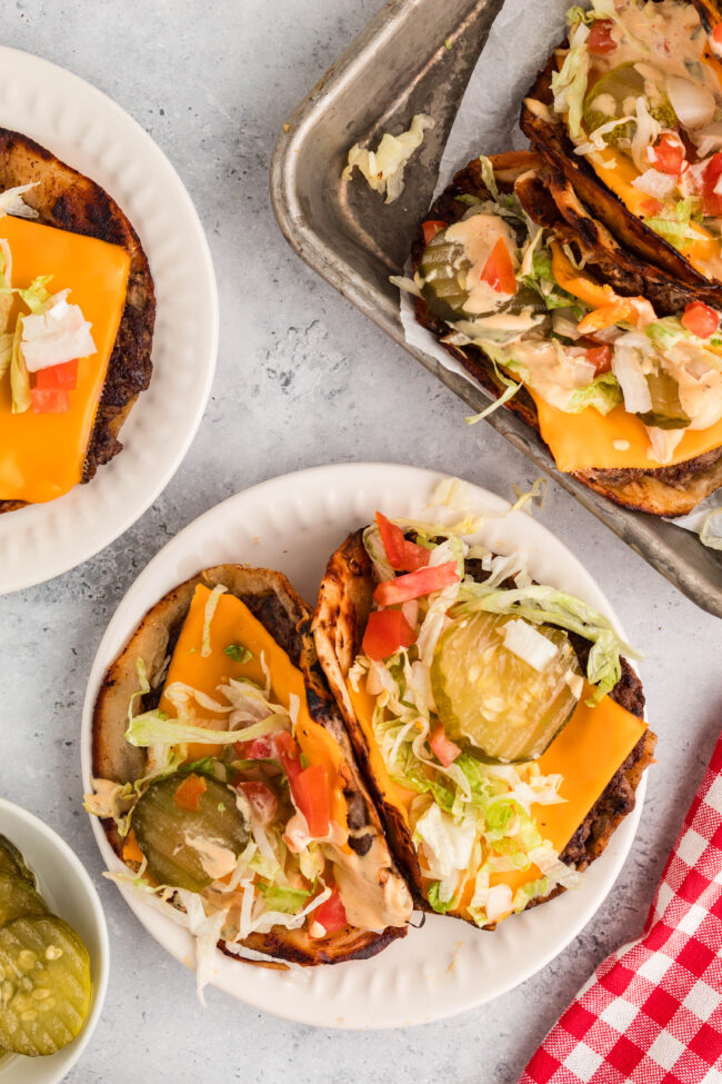 smash burger tacos on a white plate with red napkin