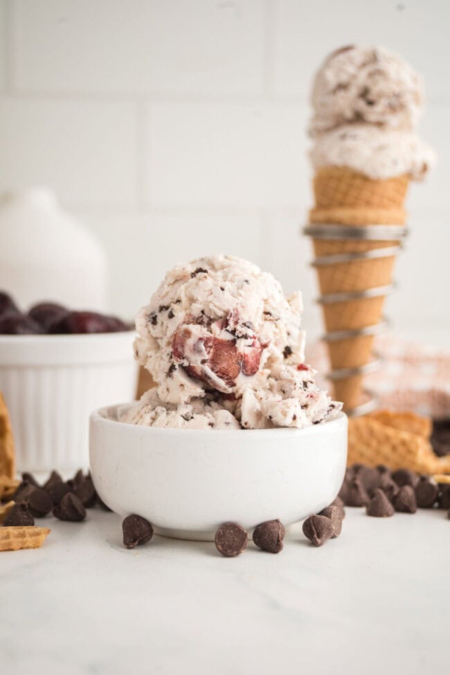 homemade no-churn Cherry Garcia ice cream scoops in waffle cone stand