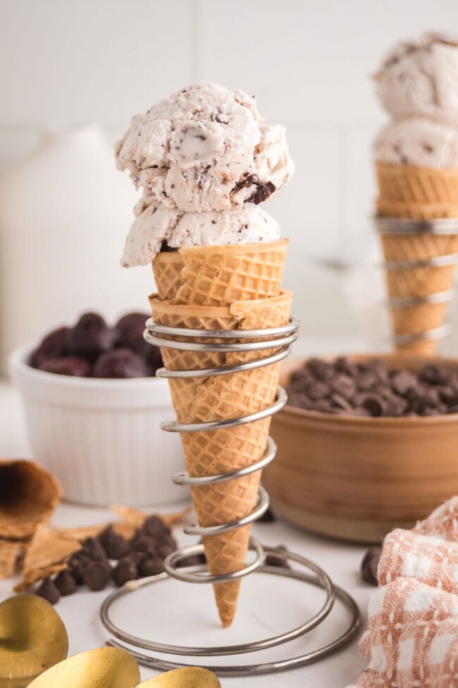waffle cone filled with homemade Cherry Garcia ice cream with chocolate chunks and sweet cherries