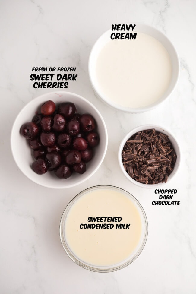 ingredients for no-churn Cherry Garcia ice cream including cherries, chocolate, heavy cream, and sweetened condensed milk