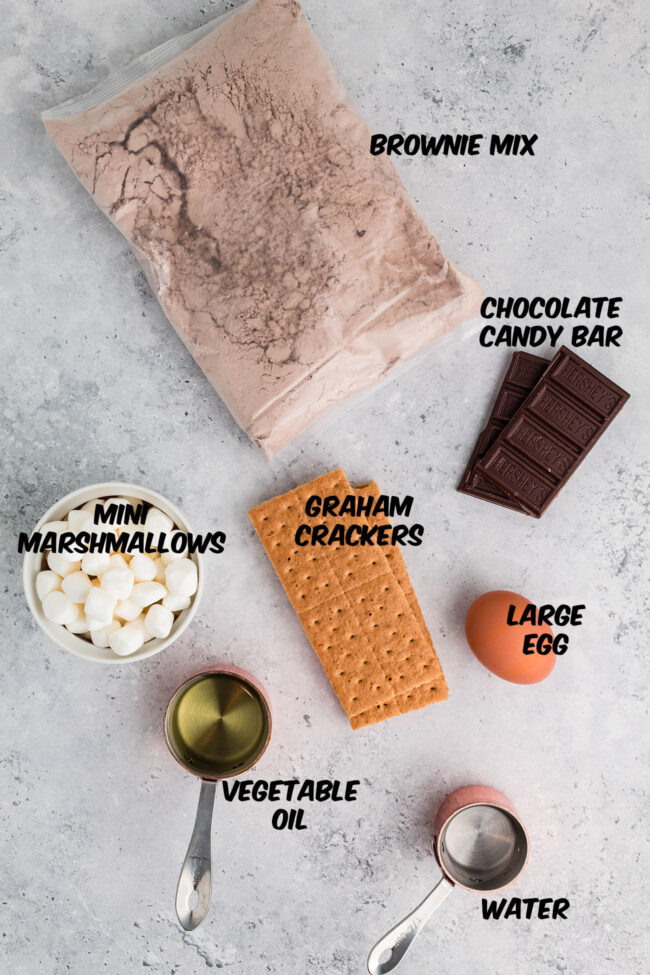 ingredients for s’mores brownies with graham cracker crust, gooey marshmallow topping, and melted chocolate