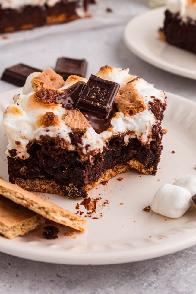 close up s’mores brownie with bite showing fudgy chocolate center and marshmallow topping