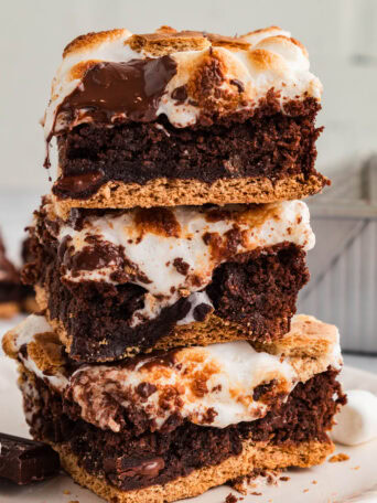 stacked s’mores brownies with graham cracker crust, gooey marshmallow topping, and melted chocolate
