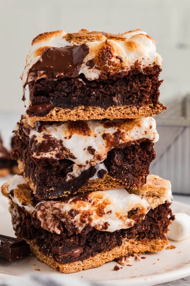 stacked s’mores brownies with graham cracker crust, gooey marshmallow topping, and melted chocolate