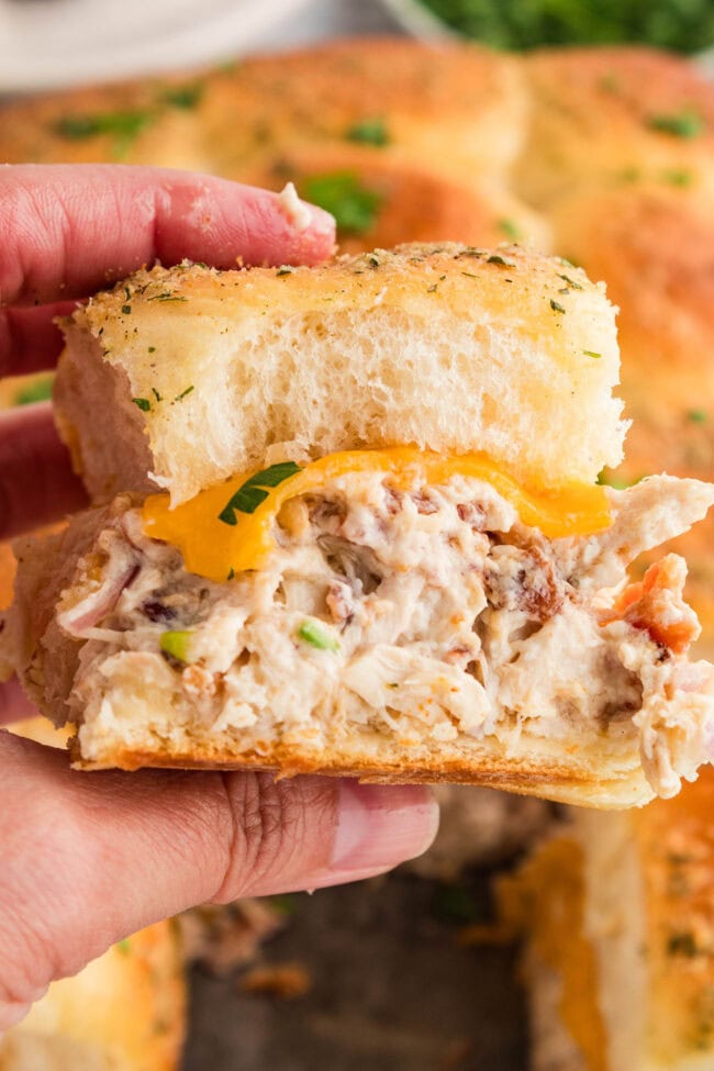 hand held cheesy slider with chicken bacon and ranch