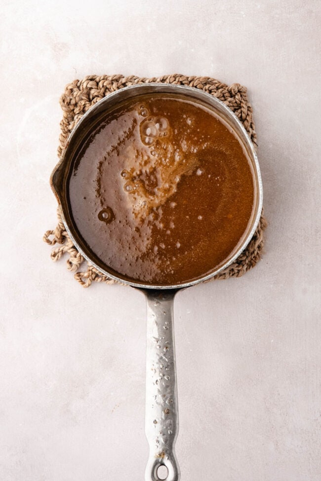 Apple cider caramel sauce in a saucepan.