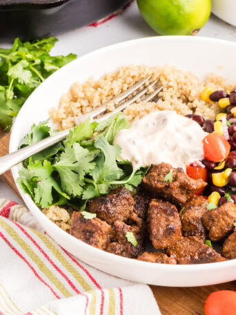 Homemade Southwest steak bowl with seasoned sirloin steak, rice, black bean and corn salad, and creamy Southwest sauce.