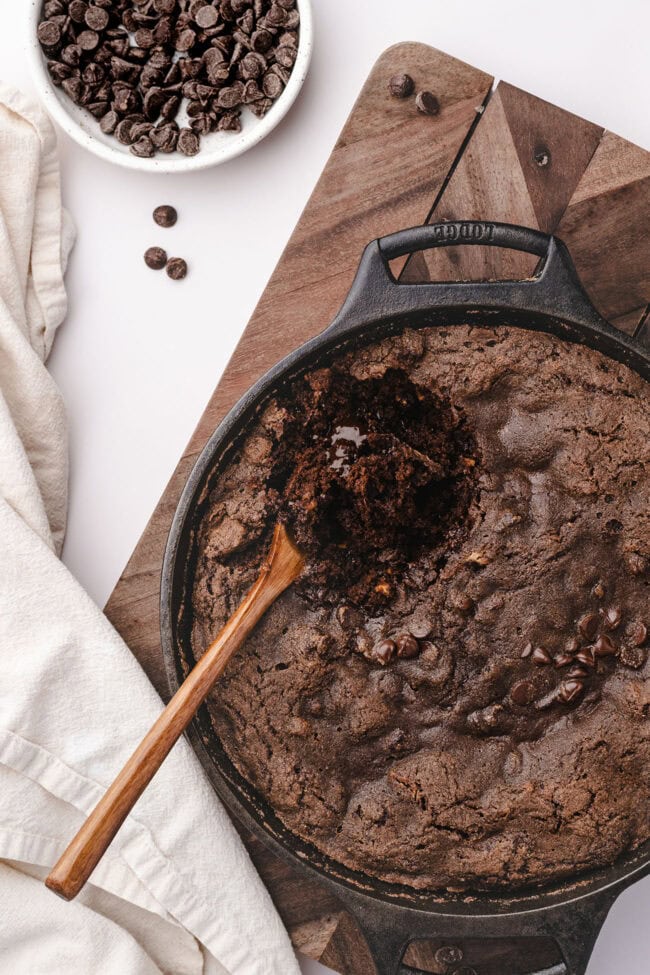 Wooden spoon resting in gooey chocolate cobbler