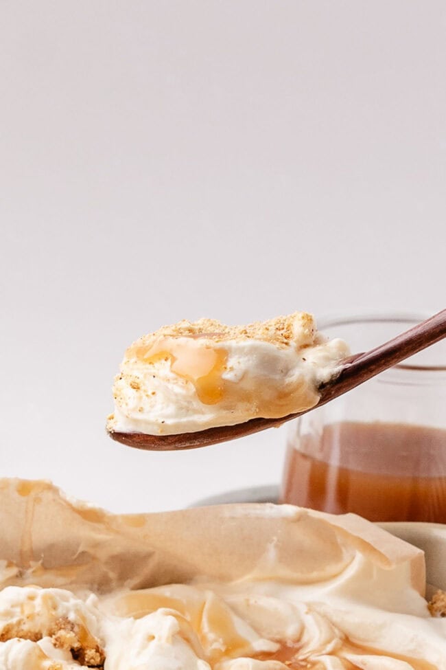Spoonful of salted caramel scoopable cheesecake lifted from the baking dish