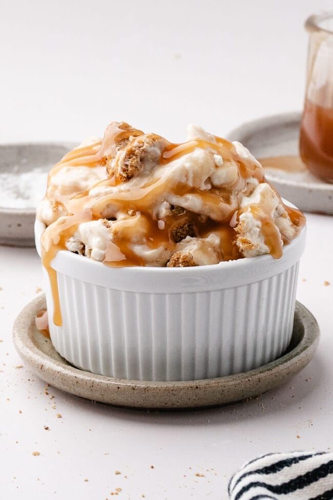 Salted caramel scoopable cheesecake served in a small dessert bowl with caramel drizzle
