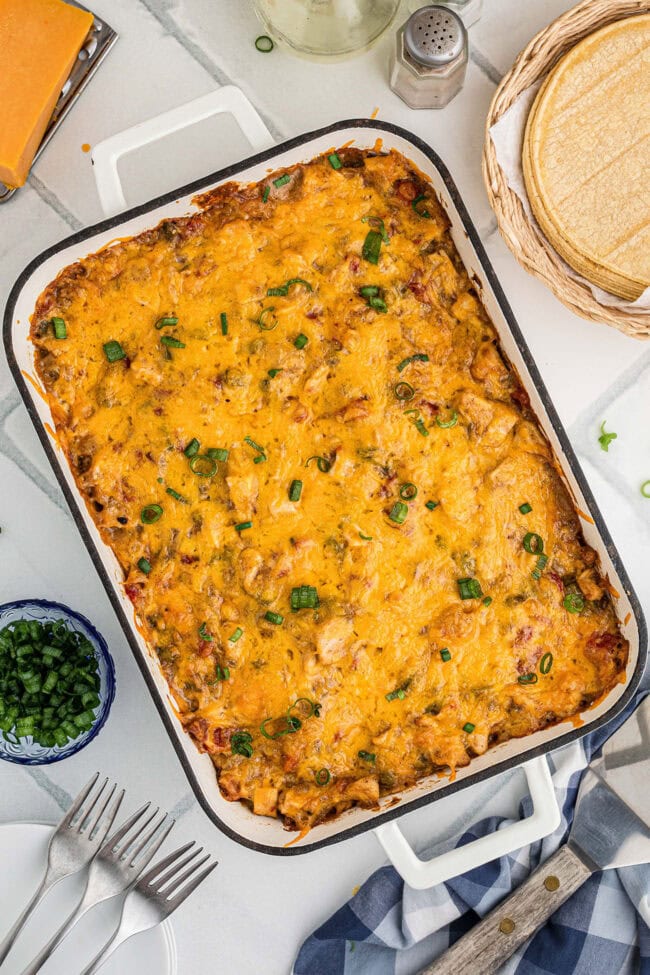 Baked King Ranch chicken casserole with melted cheddar and sliced green onions.