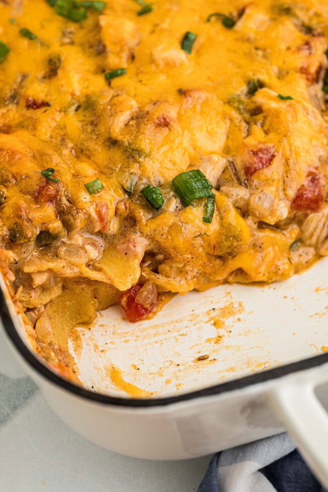 Close-up of King Ranch chicken casserole showing chicken, tomatoes, tortillas, and melted cheese.