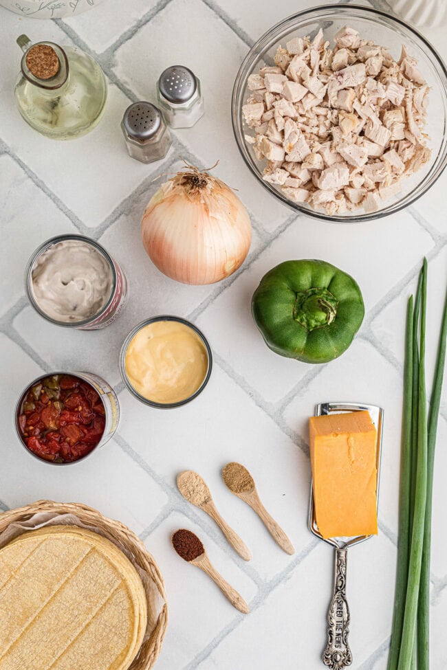 Chicken, corn tortillas, cheddar cheese, canned soups, tomatoes, peppers, onion, and seasonings for King Ranch chicken casserole.